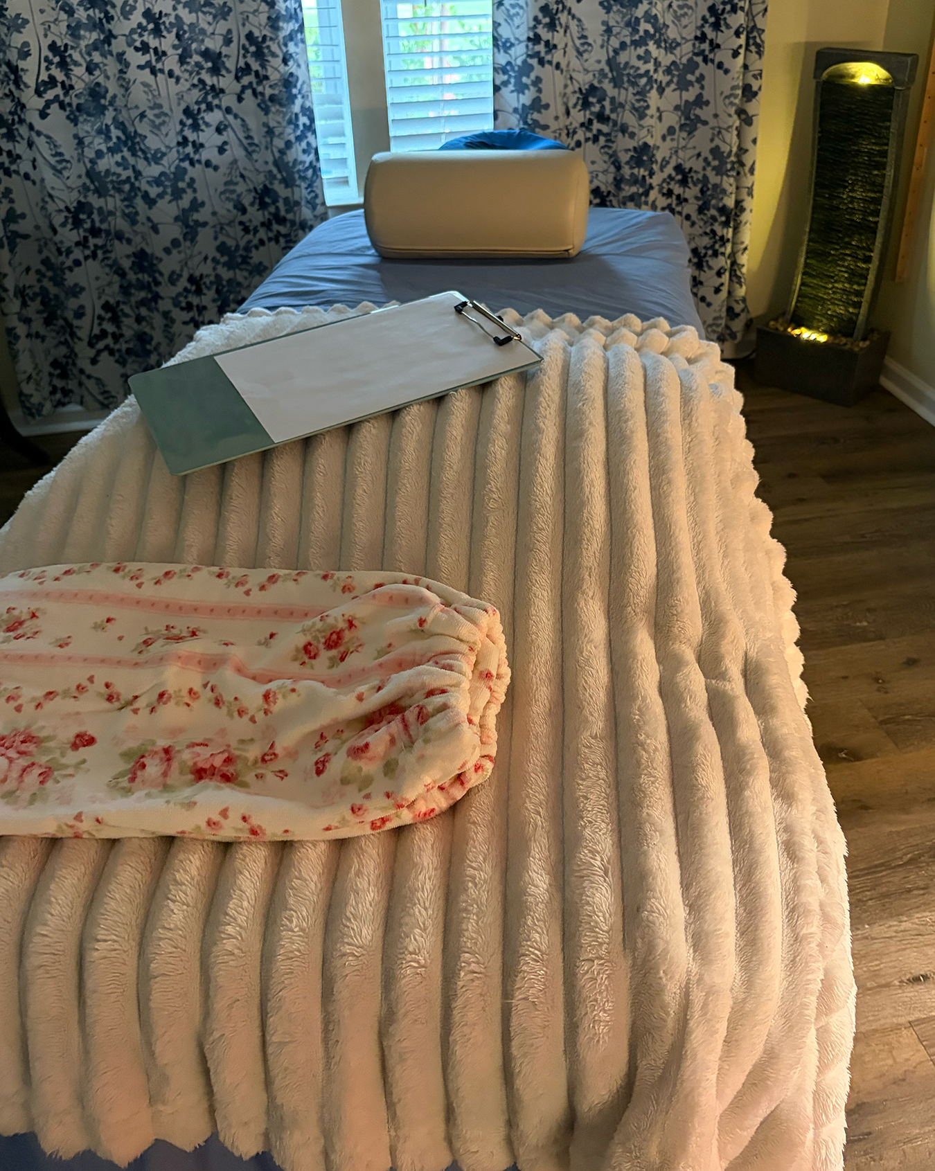 Calm, warmly lit private massage therapy studio