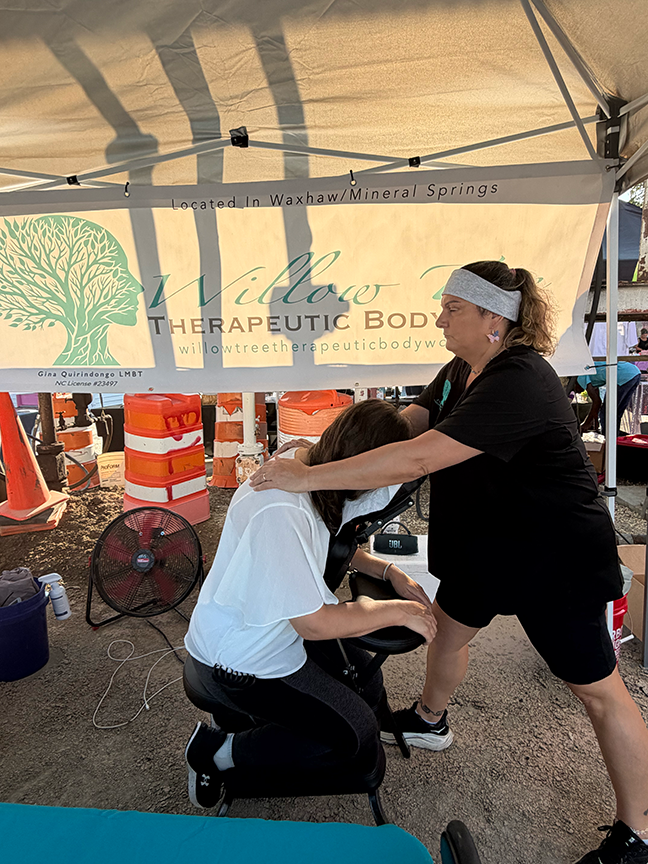 Gina providing chair massage at the Live Well Charlotte event